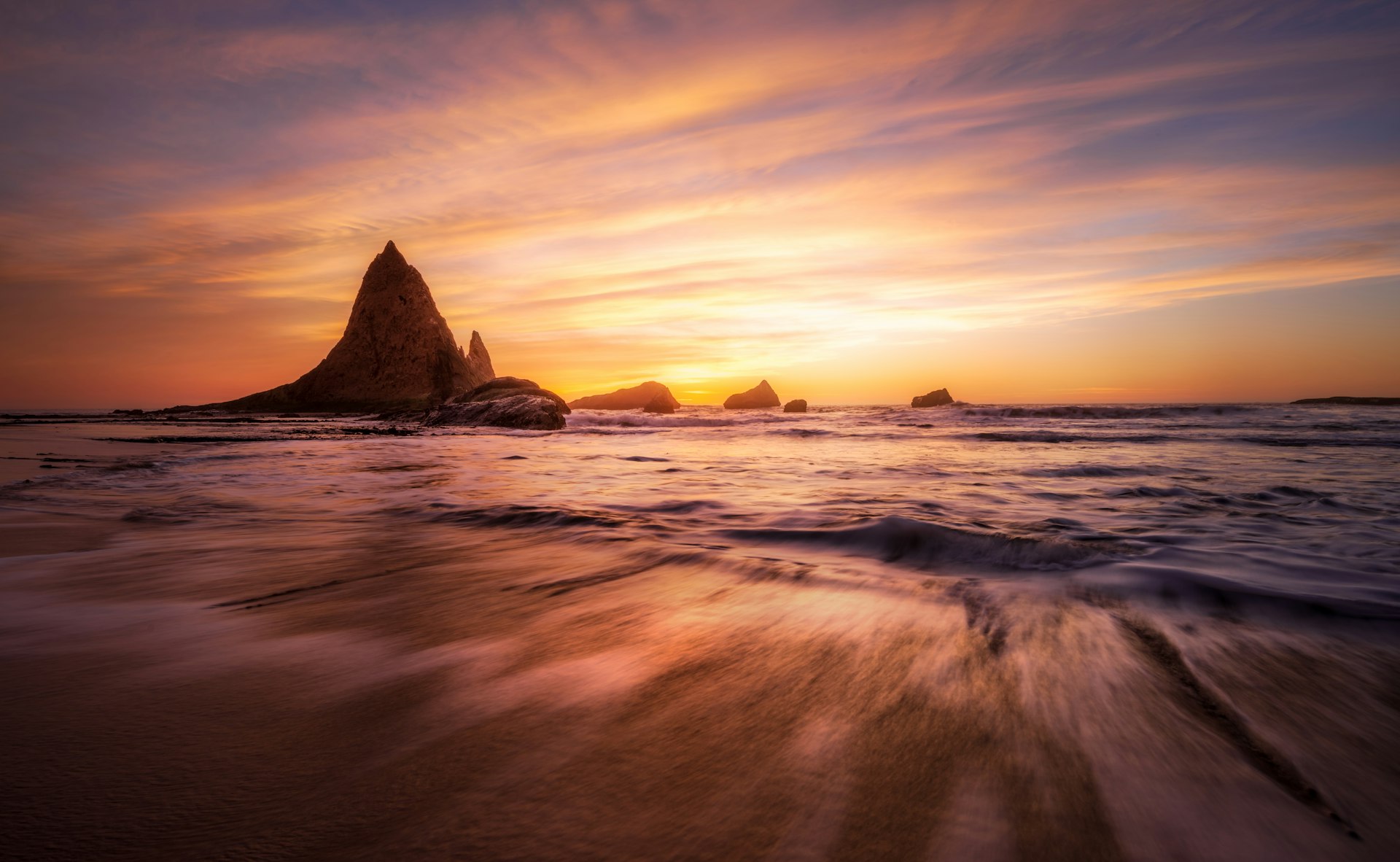 Dillon Beach sunset with surfers in the water